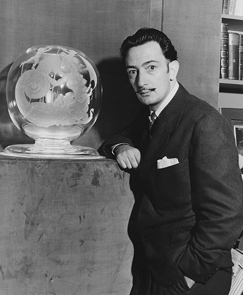 Salvador Dali poses with his piece from the 27 Artists in Crystal series
